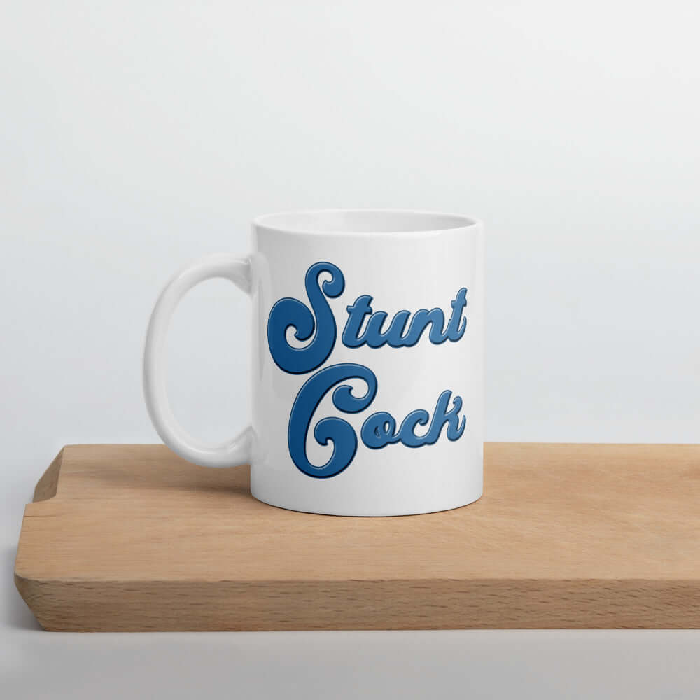 White ceramic mug with the words Stunt Cock printed on both sides in blue.