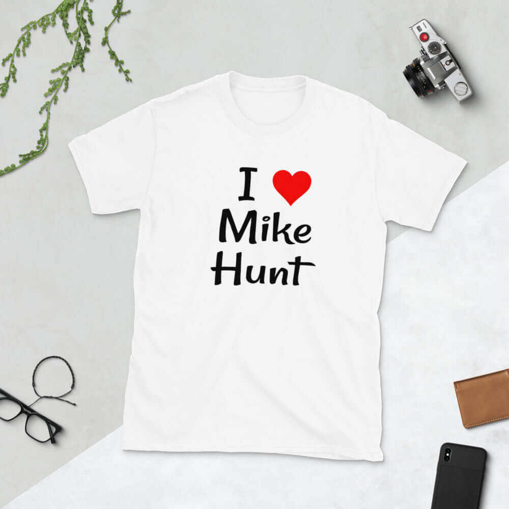 White t-shirt with pun I heart Mike Hunt printed on the front. The heart is red.