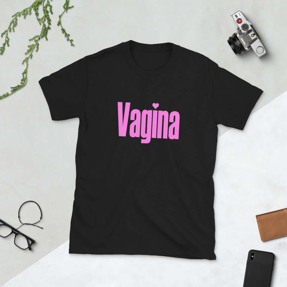 Black t-shirt with the word Vagina printed on the front. The word vagina is in pink color text.