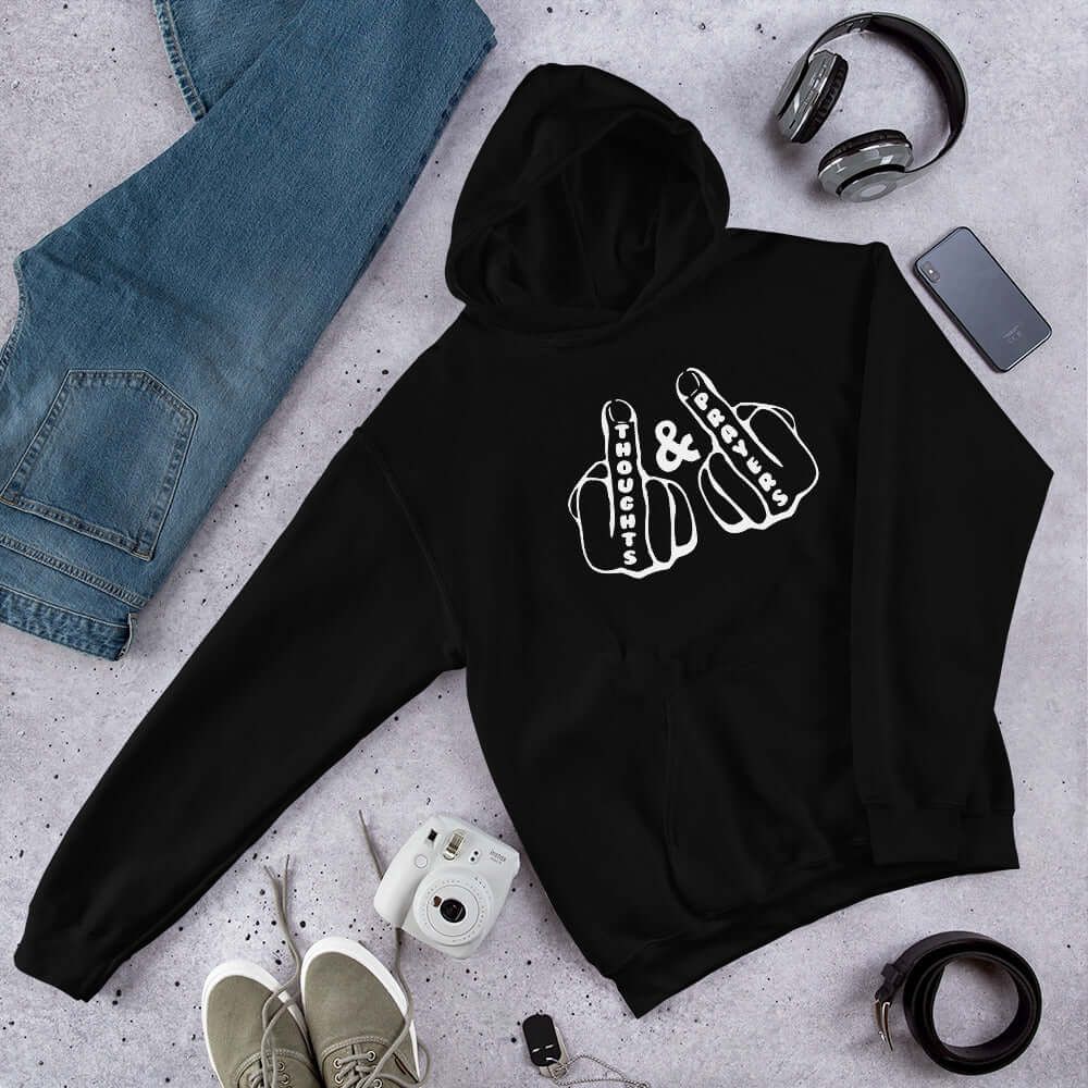 Black hoodie sweatshirt with an image of 2 line drawing hands with the middle fingers up. The word Thoughts is printed on one middle finger and the word Prayers is printed on the other middle finger. The graphics are printed on the front of the hoodie.