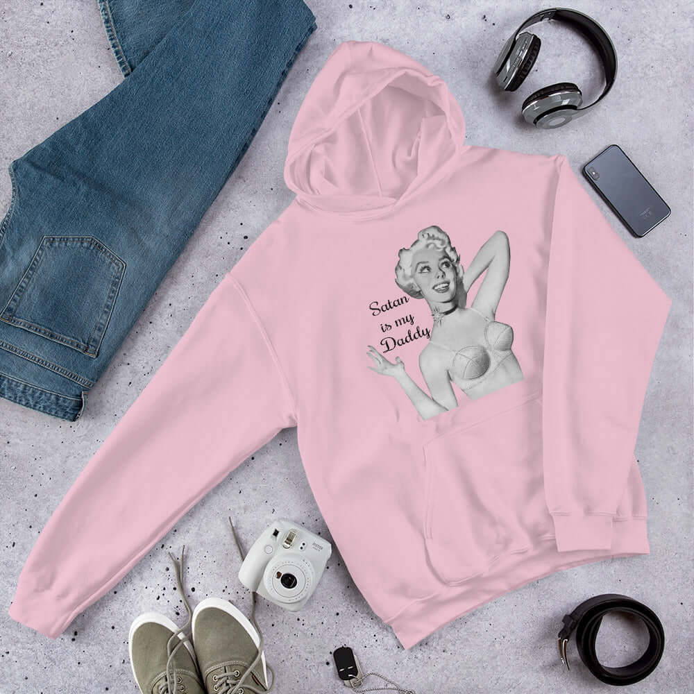 Light pink hoodie sweatshirt with image of a retro black & white pin-up model and the phrase Satan is my Daddy printed on the front.