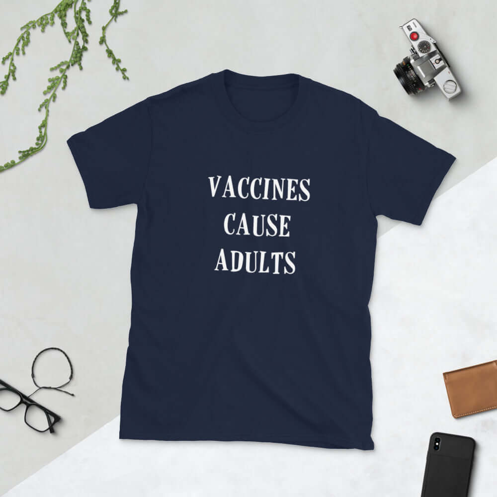 Navy blue t-shirt with the words Vaccines cause adults printed on the front.