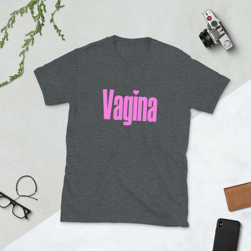 Dark heather grey t-shirt with the word Vagina printed on the front. The word vagina is in pink color text.