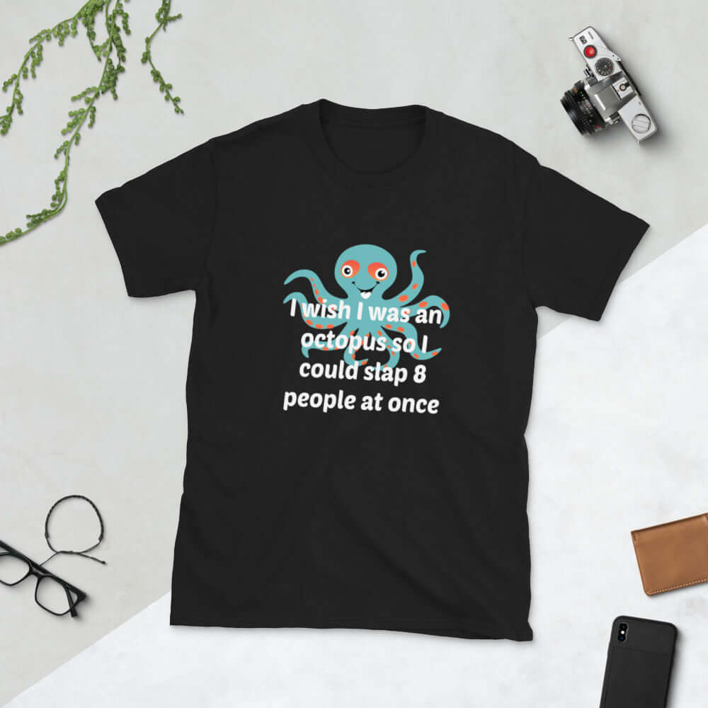 Black Woman wearing a black t-shirt with an image of an octopus and the phrase I wish I was an octopus so I could slap 8 people at once printed on the front of the shirt.