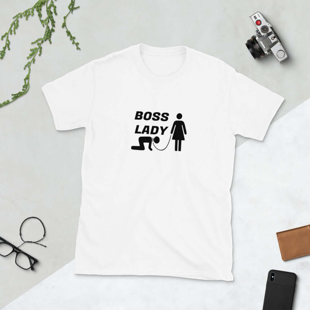 White t-shirt with graphic of collared and leashed man on his hands and knees being led by a woman and the words Boss lady printed on the front.