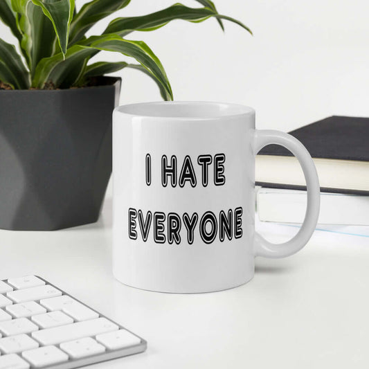 White ceramic mug with the words I hate everyone printed on both sides.