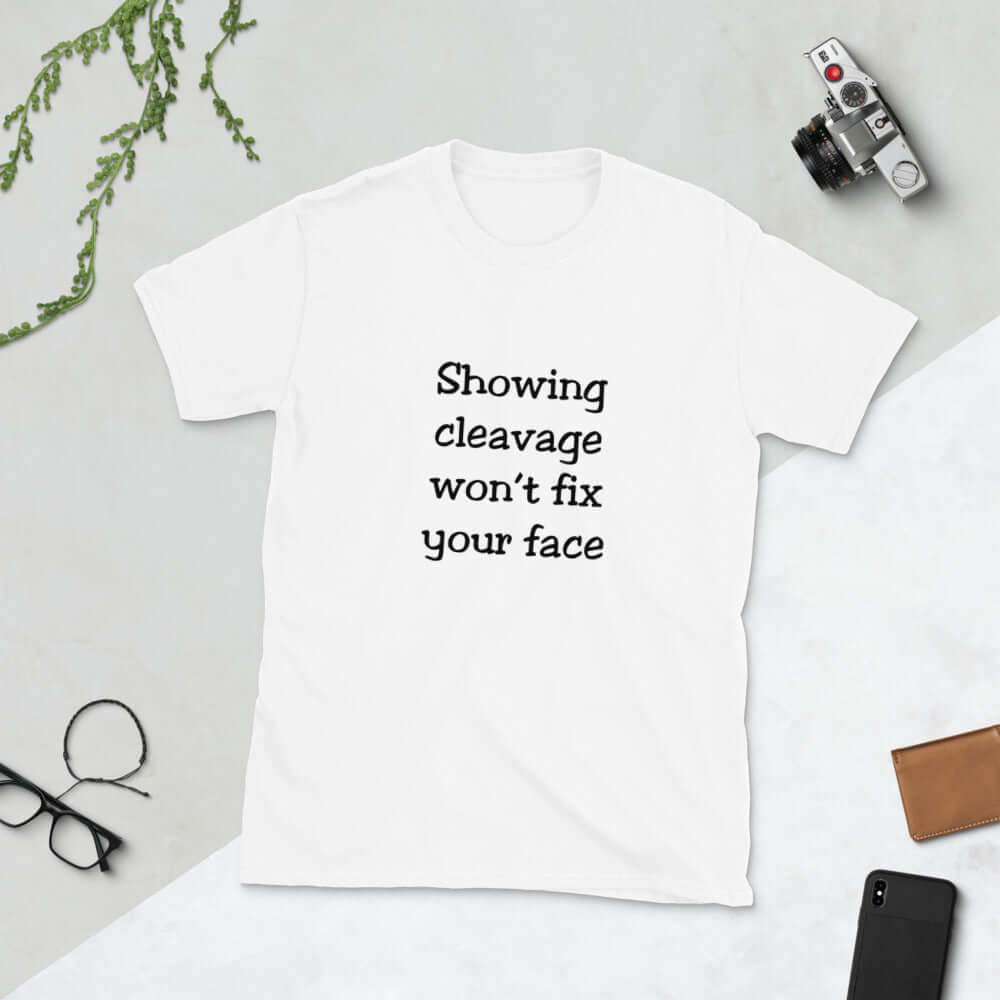 White t-shirt with the phrase Showing cleavage won't fix your face printed on the front.