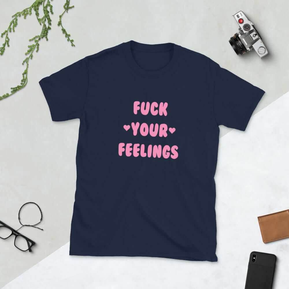 Navy blue t-shirt with the words Fuck your feelings printed on the front in pink. There are cute pink hearts next to the words.