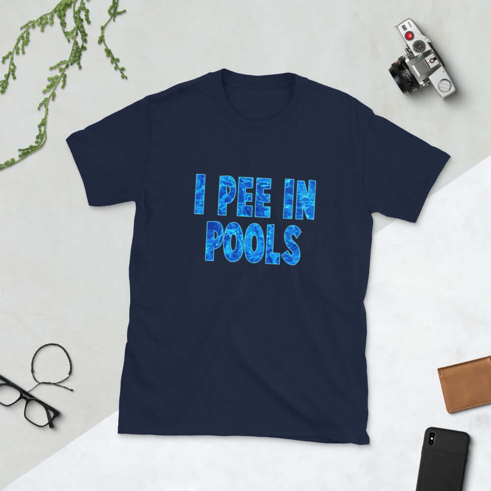 Navy blue t-shirt with the words I pee in pools printed in a font that looks like water. The graphics are printed on the front of the shirt.