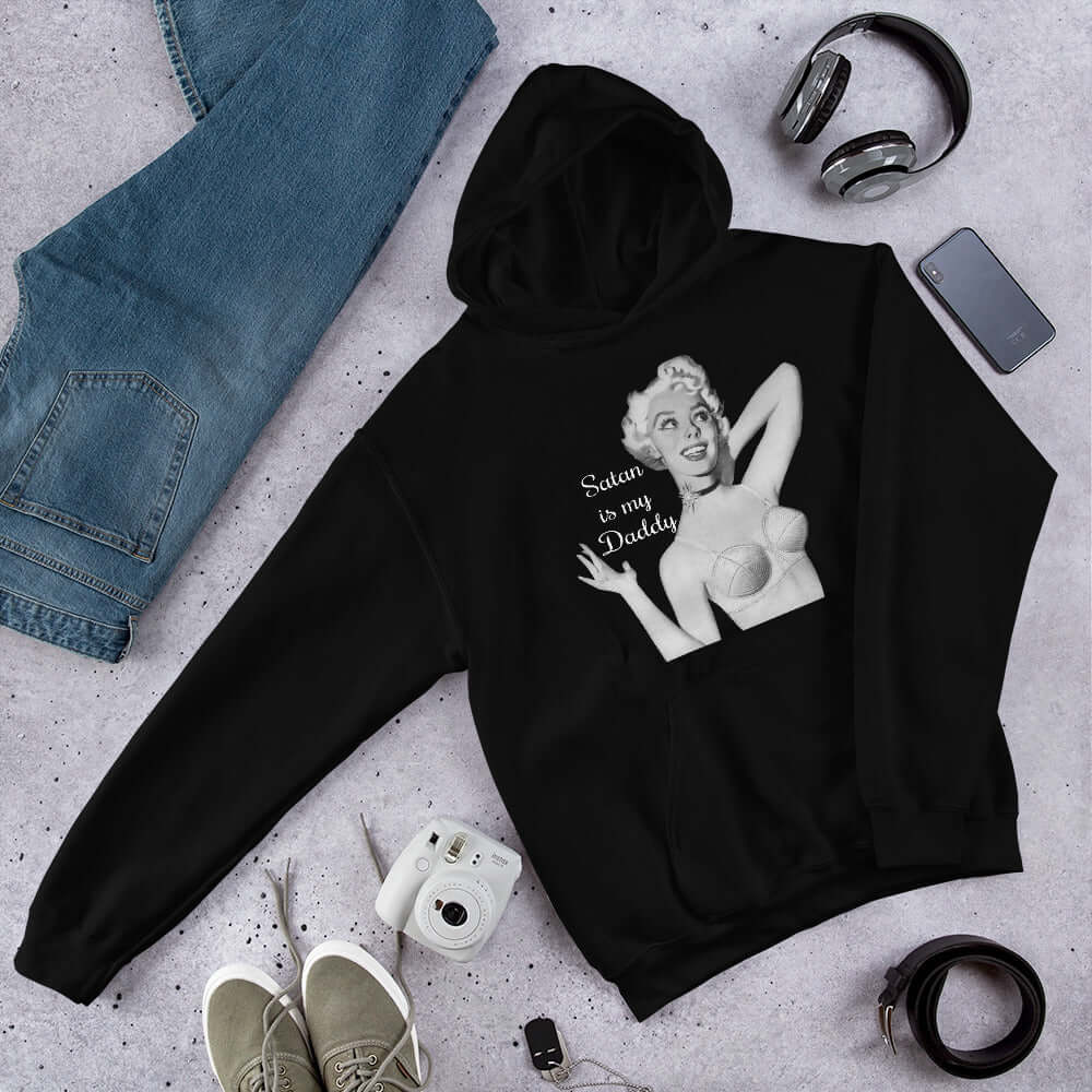 Black hoodie sweatshirt with image of a retro black & white pin-up model and the phrase Satan is my Daddy printed on the front.