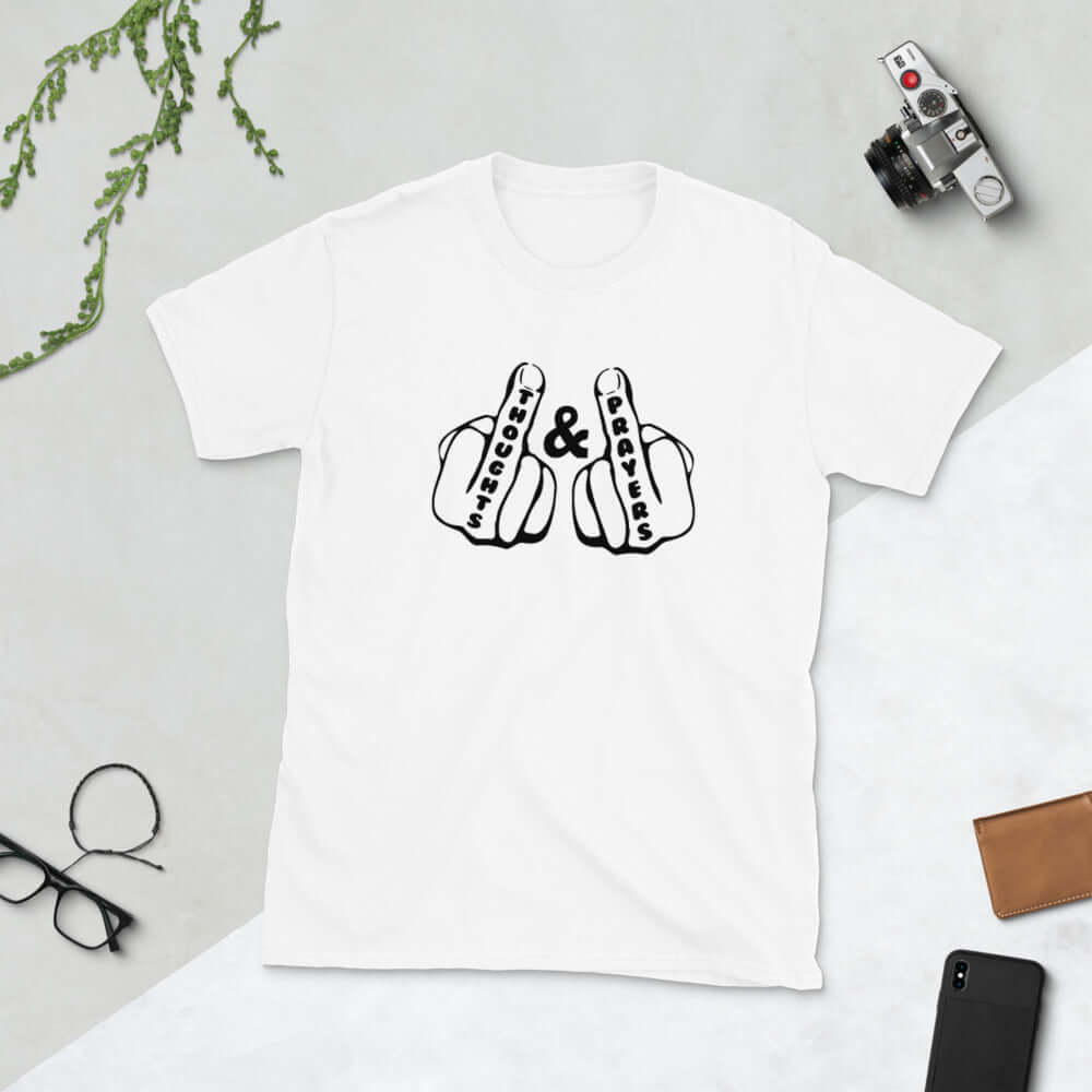 White t-shirt with an image of 2 line drawing hands with the middle fingers up. The word Thoughts is printed on one middle finger and the word Prayers is printed on the other middle finger. The graphics are printed on the front of the shirt.