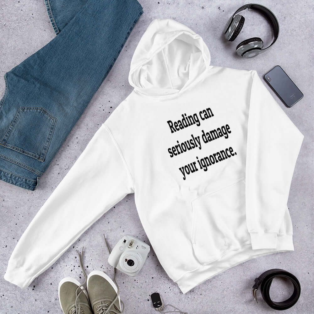 White hoodie sweatshirt with the phrase Reading can seriously damage your ignorance printed on the front.