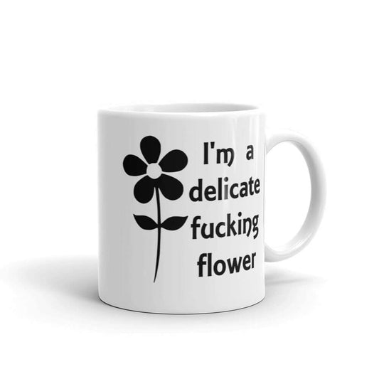 White ceramic mug with image of a flower and the words I'm a delicate fucking flower printed on both sides.