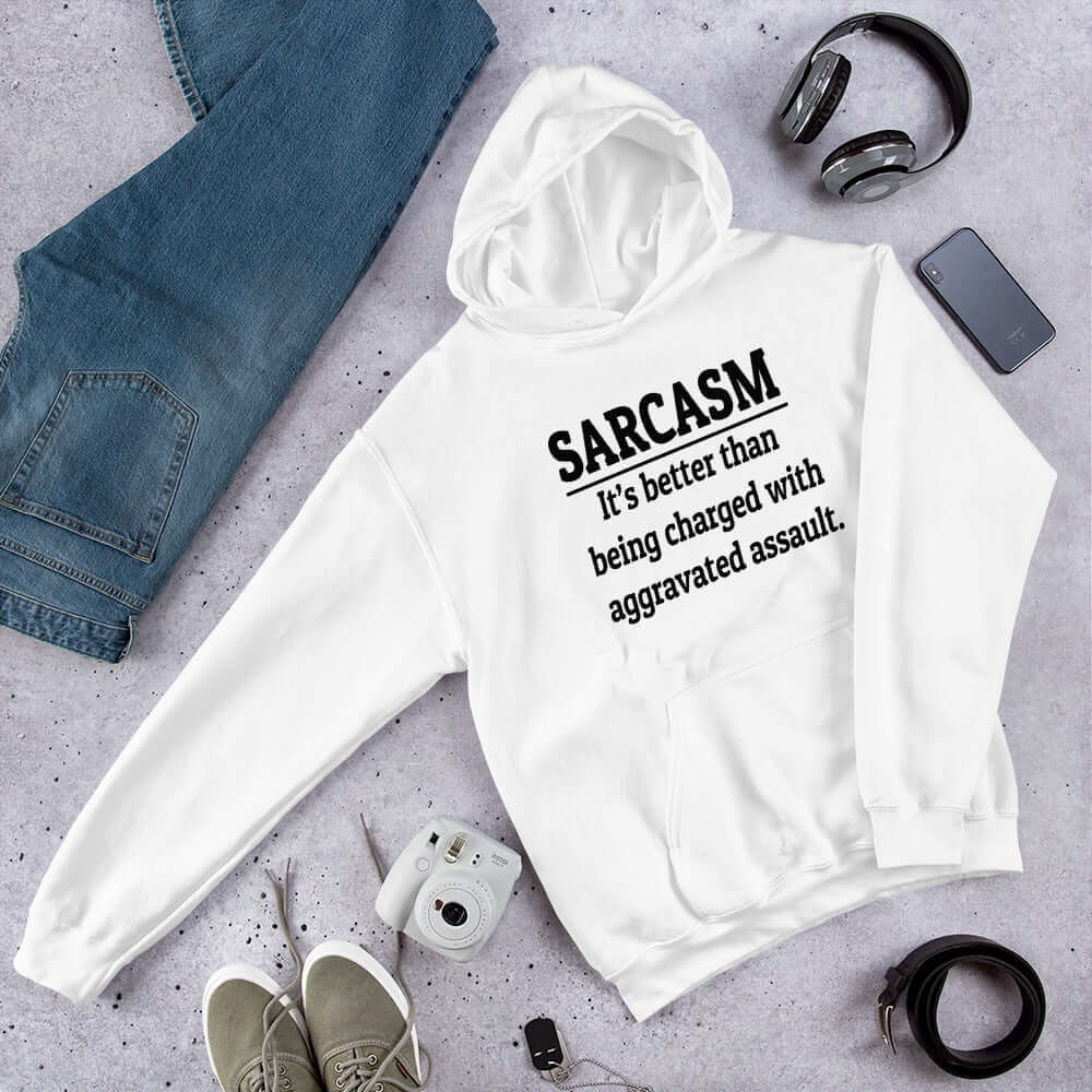White hoodie sweatshirt with the phrase Sarcasm, it's better than being charged with aggravated assault printed on the front of the hoodie.