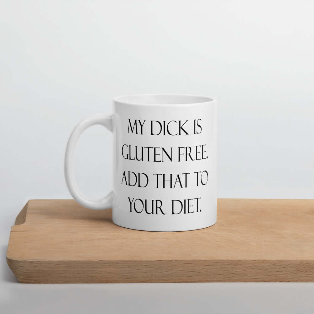 White ceramic coffee mug with the funny phrase My dick is gluten free, add that to your diet printed on both sides of the mug.