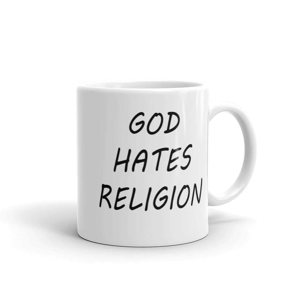 White ceramic mug with with the words God hates religion printed on both sides of the mug.