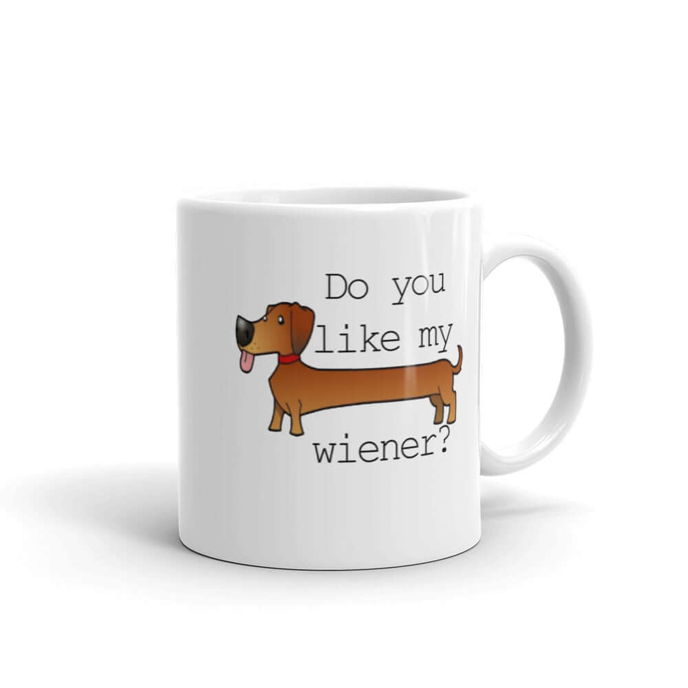 White ceramic coffee mug with an image of a dachshund and the phrase Do you like my wiener printed on both sides of the mug.