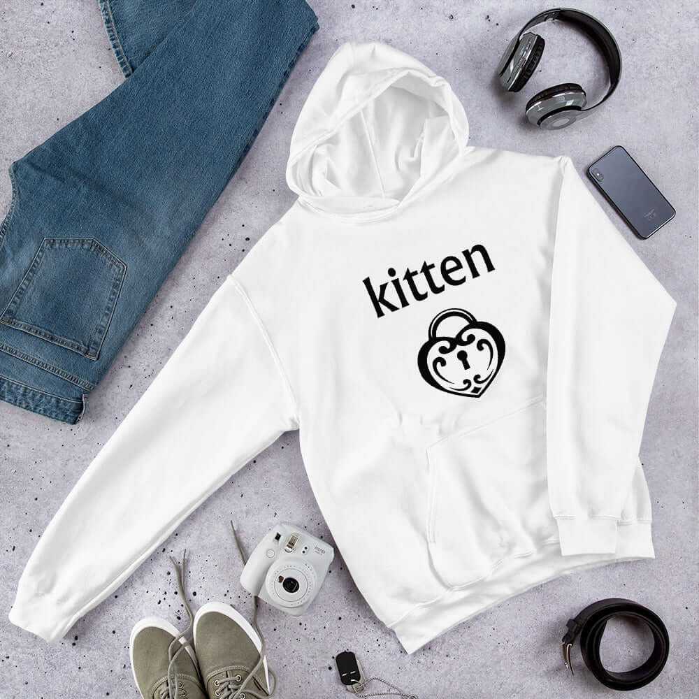 White hoodie sweatshirt with an image of a BDSM heart shaped lock and the word kitten printed on the front.