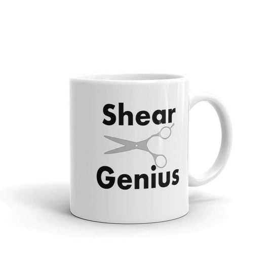 White ceramic coffee mug with an image of haircutting shears and the words Shear Genius printed on both sides of the mug.