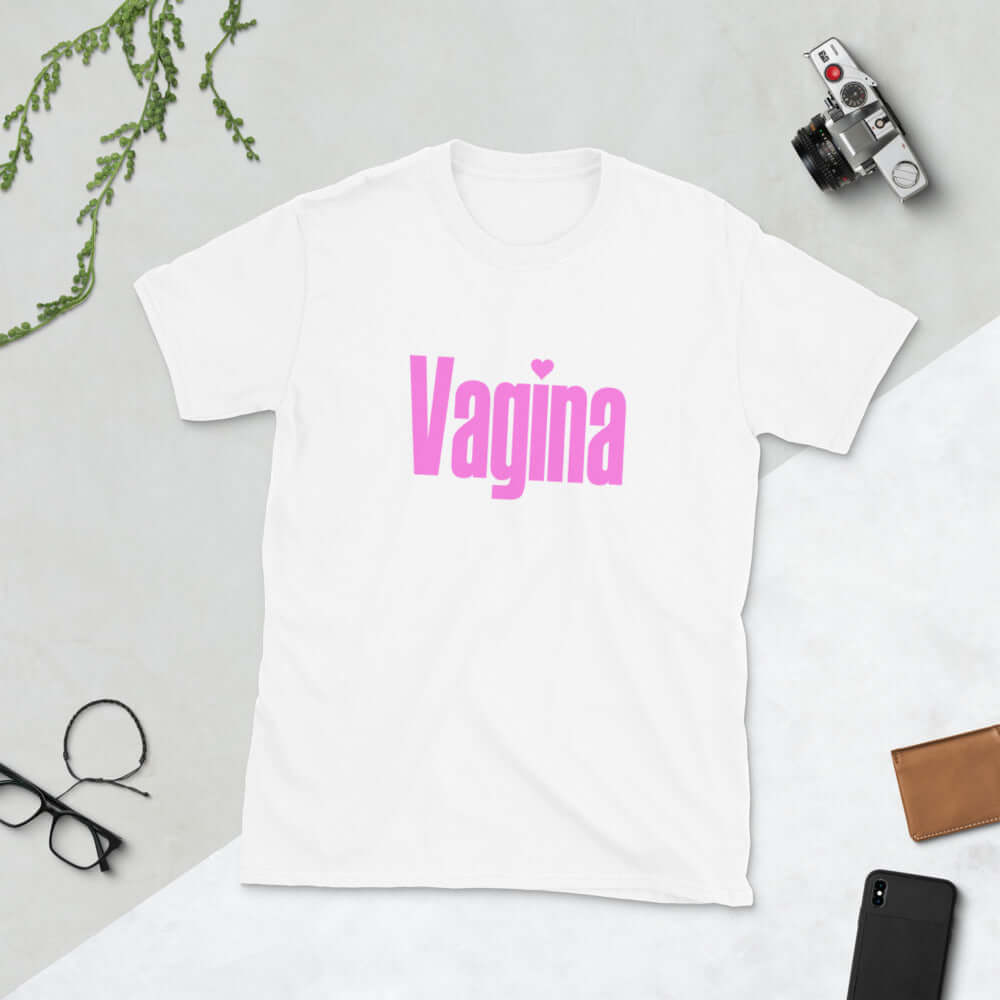 White t-shirt with the word Vagina printed on the front. The word vagina is in pink color text.