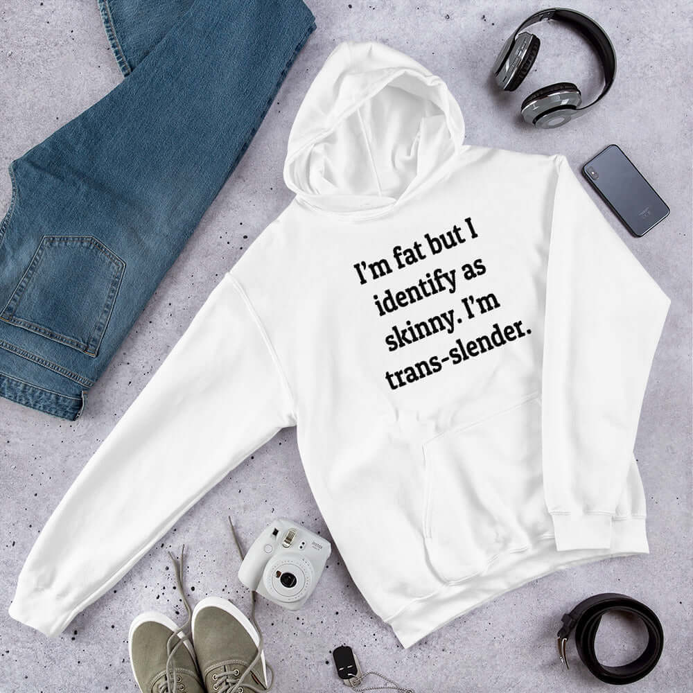 White hoodie sweatshirt with the phrase I'm fat but I identify as skinny. I'm trans-slender printed on the front.