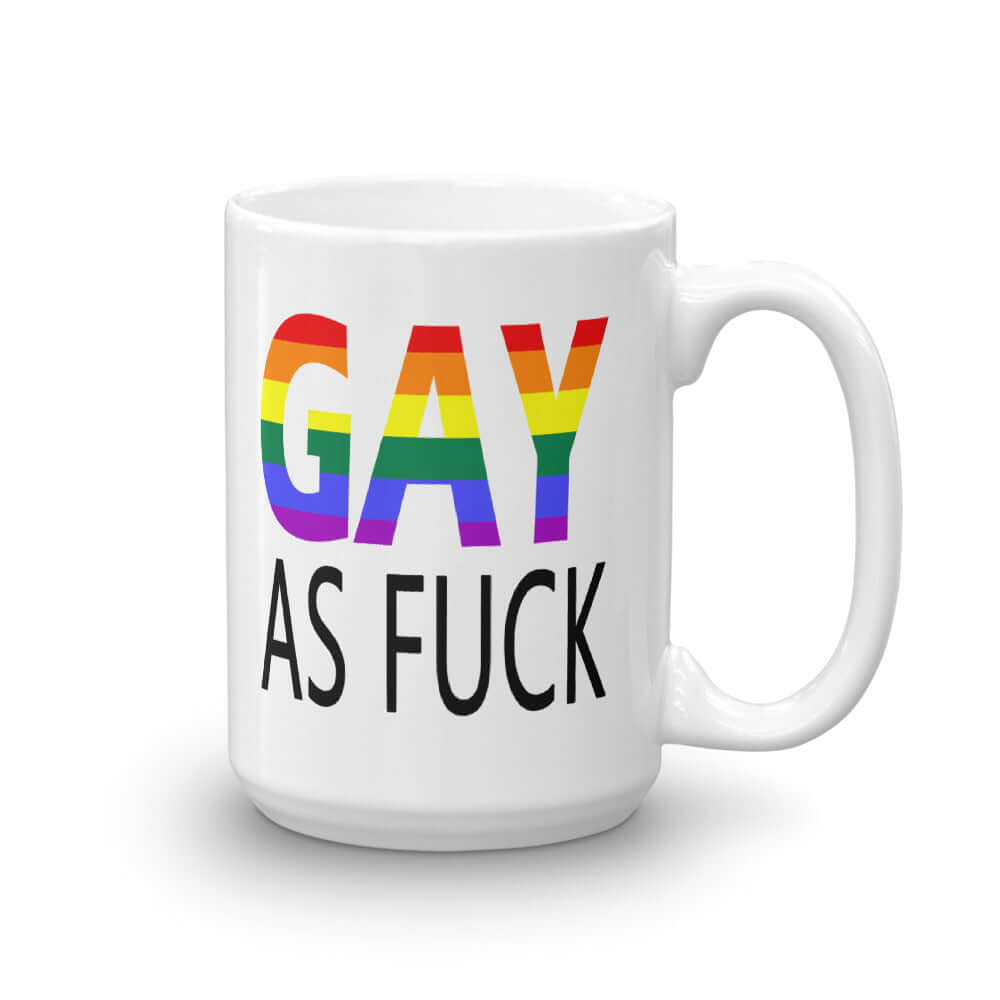 White ceramic mug with the words Gay as fuck printed on both sides. The word Gay is in rainbow stripe font.