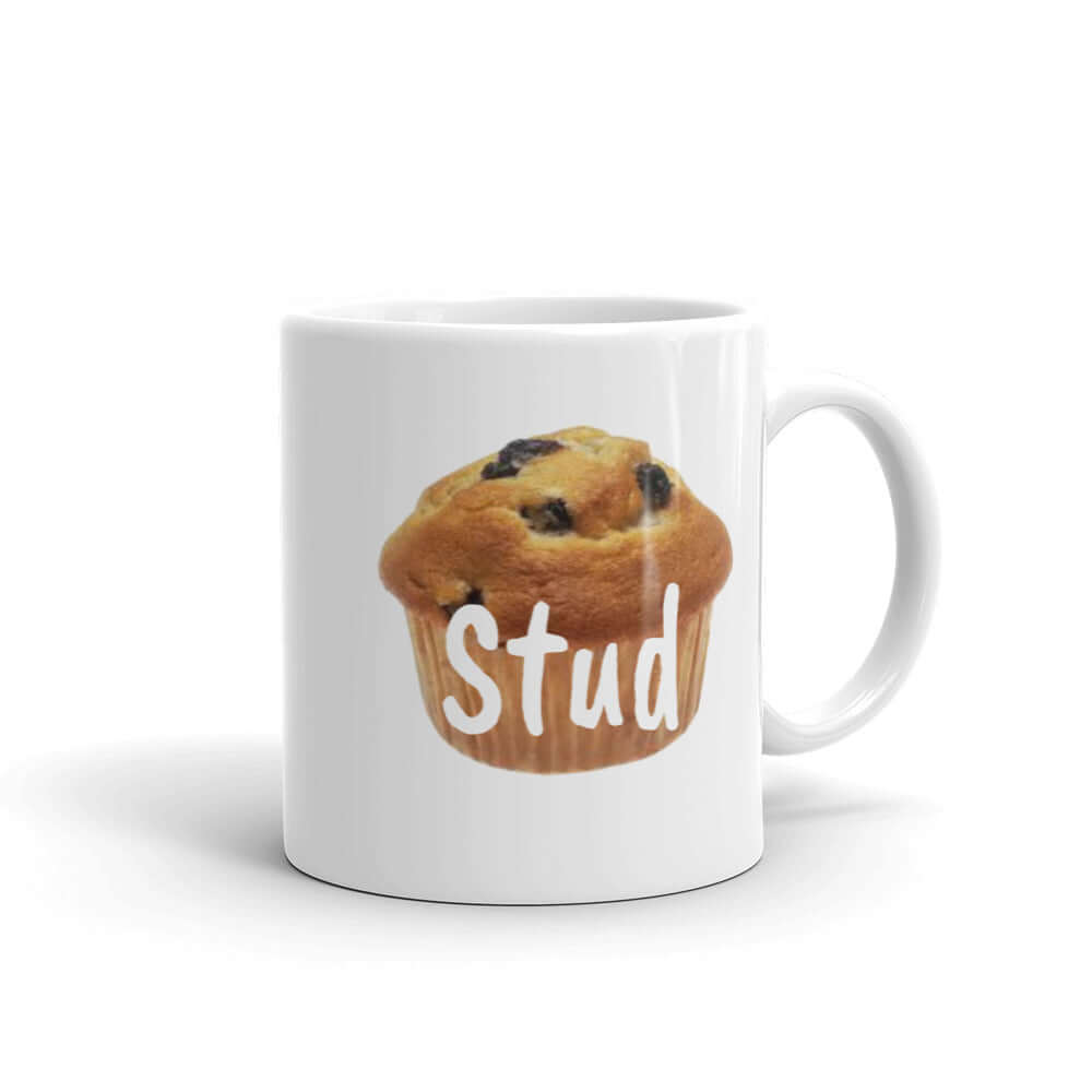 White ceramic coffee mug with an image of a blueberry muffin with the word Stud printed over the muffin. The graphics are on both sides of the mug