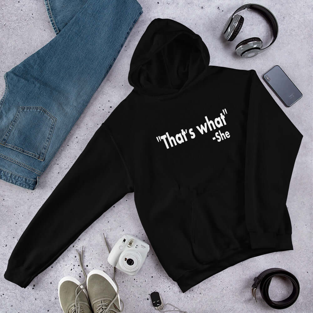 Black hoodie sweatshirt with the funny quote That's what-she printed on the front.