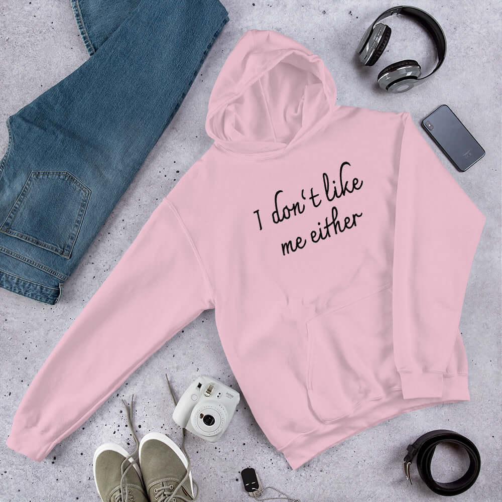 Light pink hooded sweatshirt with the words I don't like me either printed on the front.