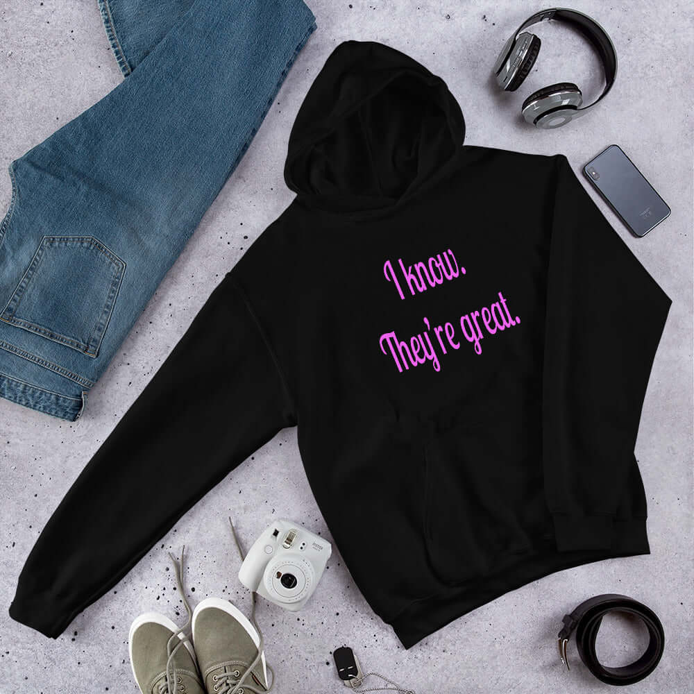 Black hoodie sweatshirt with the phrase I know, they're great printed in hot pink letters on the front of the hoodie.