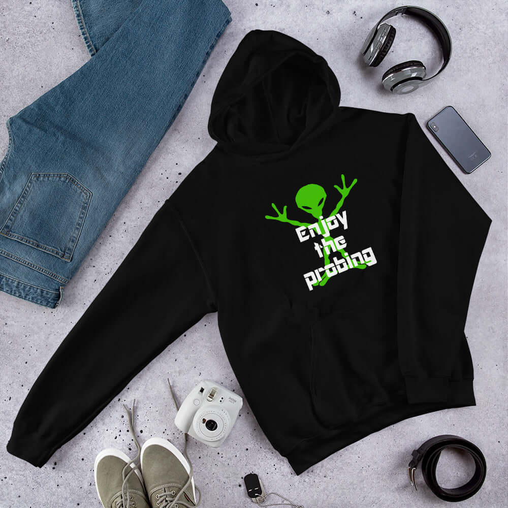 Black hoodie sweatshirt with an image of an alien and the funny phrase Enjoy the probing printed on the front.