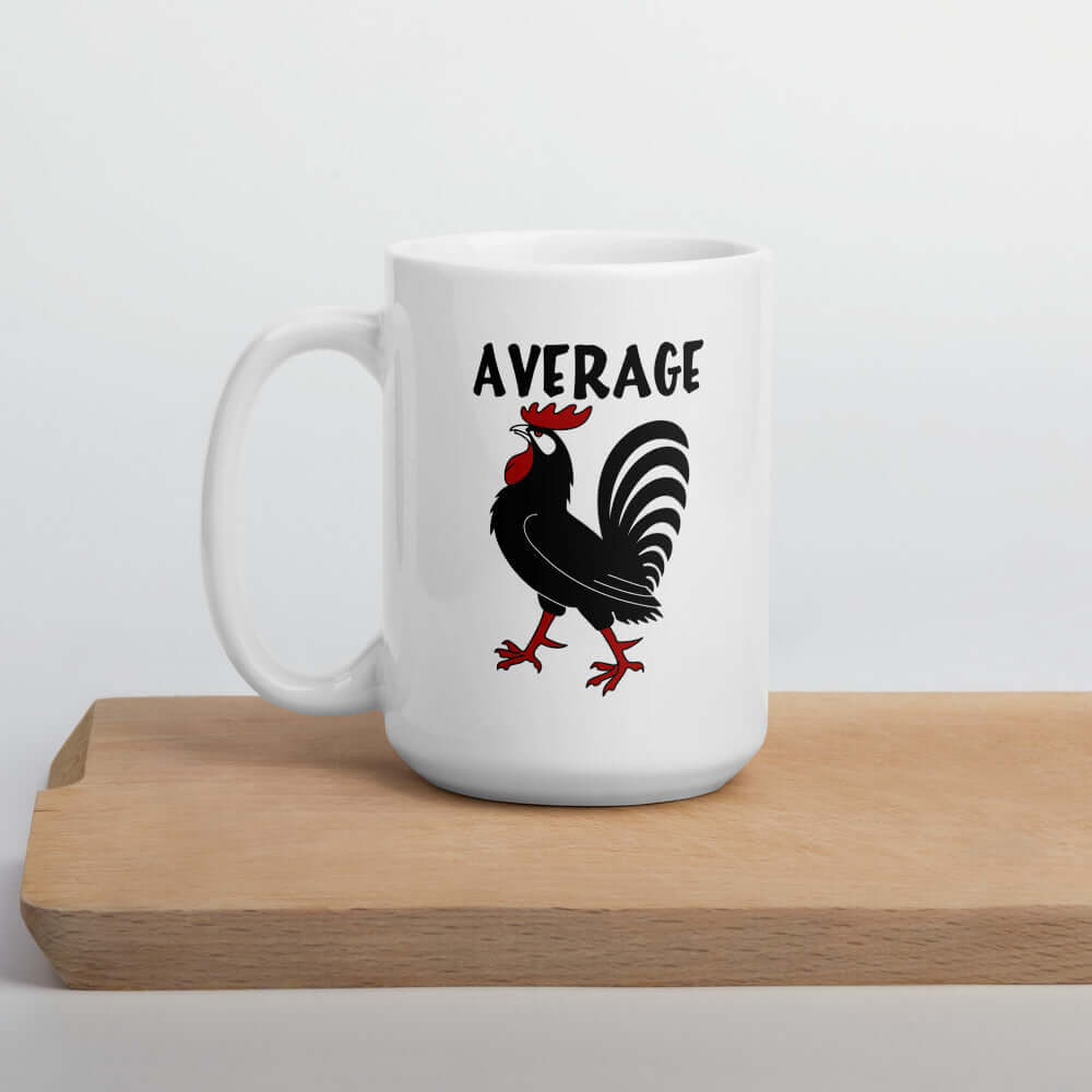 White ceramic coffee mug with image of a rooster with the word Average printed above. The design is printed on both sides of the mug.