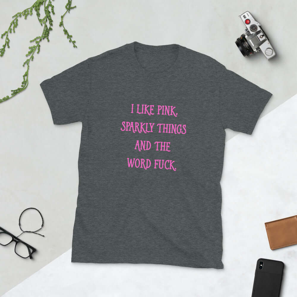 Dark heather grey t-shirt with the phrase I like pink, sparkly things and the word fuck printed in pink on the front of the shirt.