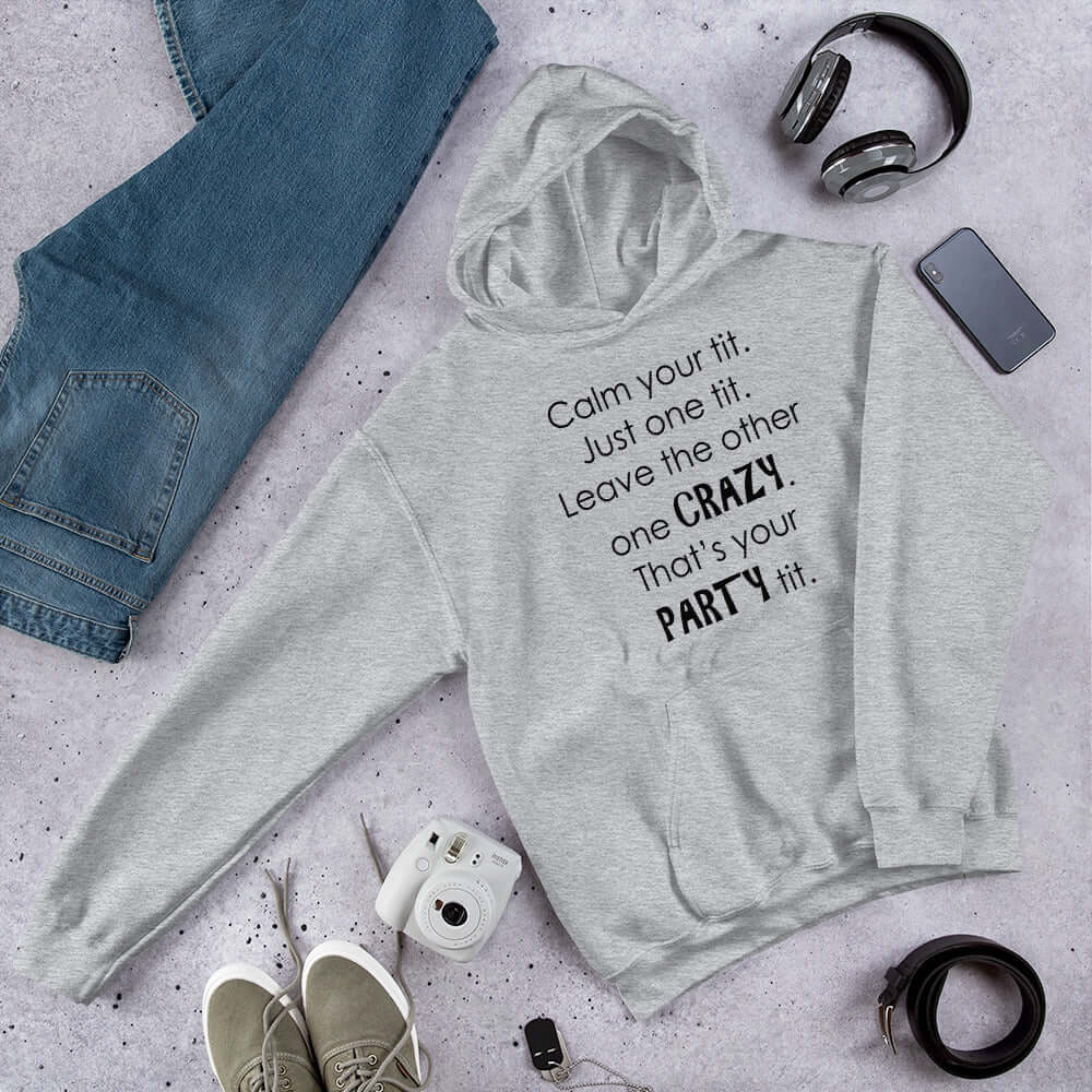 Light grey hoodie sweatshirt with the funny phrase Calm your tit, just one tit. Leave the other one crazy, that's your party tit printed on the front.