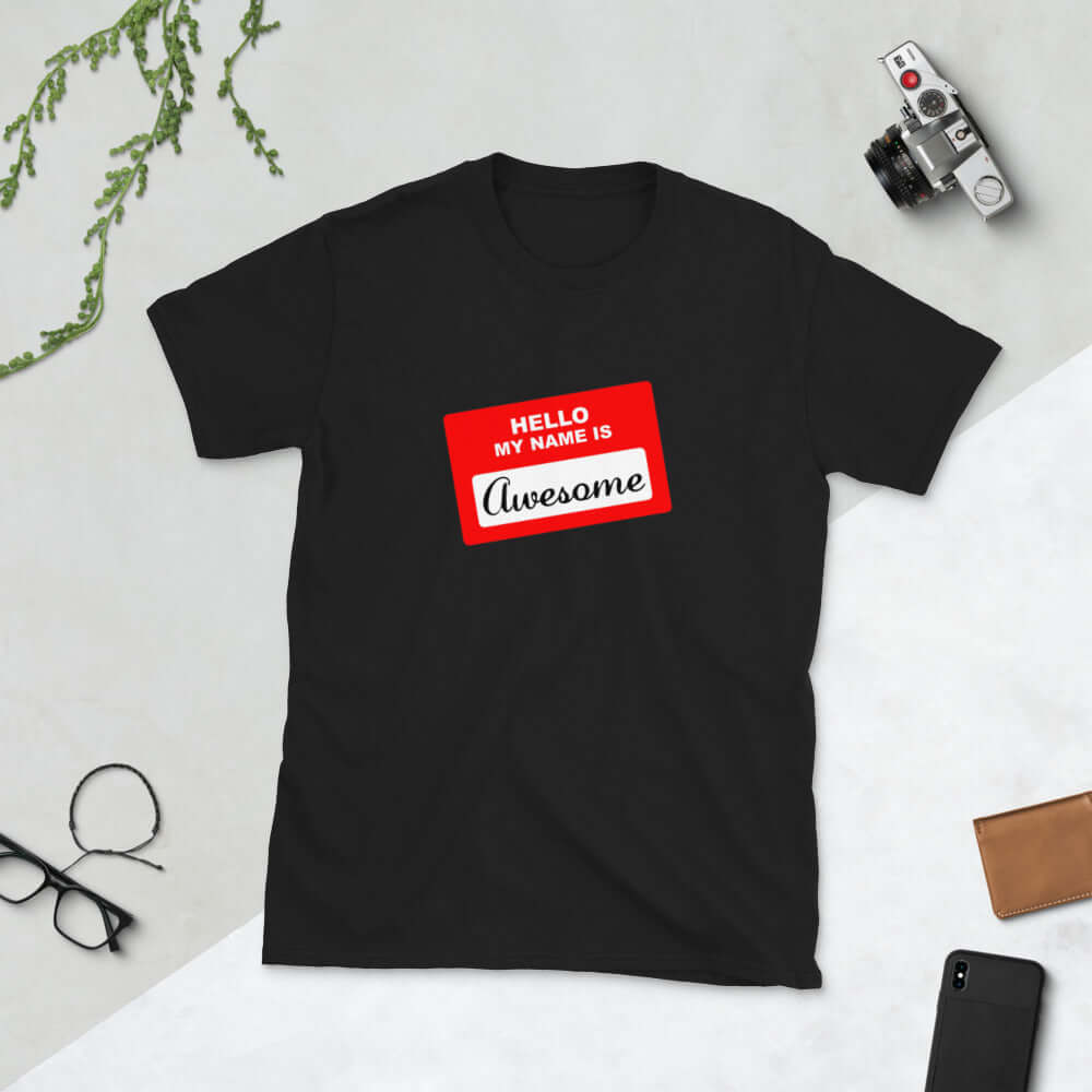 Black t-shirt with an image of a classic red and white sticker name tag that says Hello my name is Awesome printed on the front.