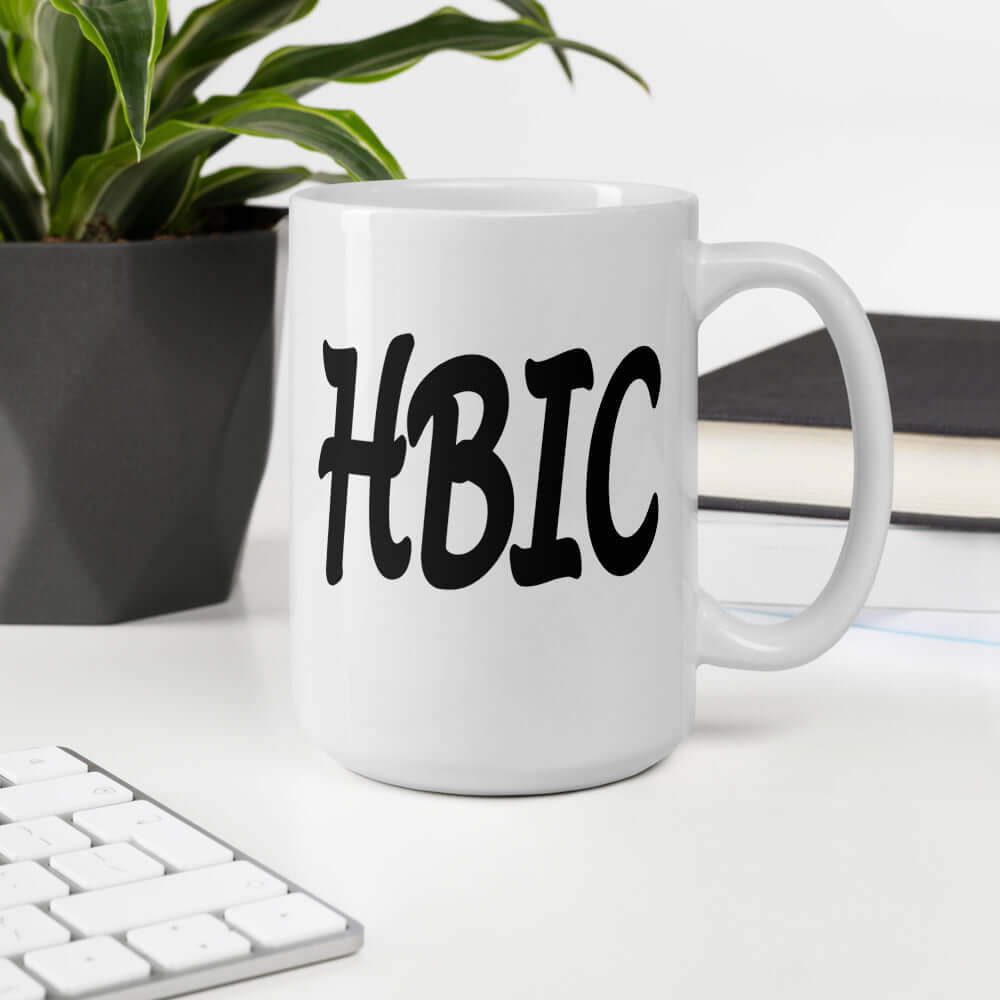 White ceramic mug with the acronym HBIC printed on both sides.