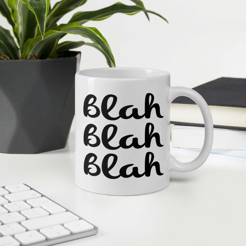 White ceramic coffee mug with the words Blah Blah Blah printed on both sides.