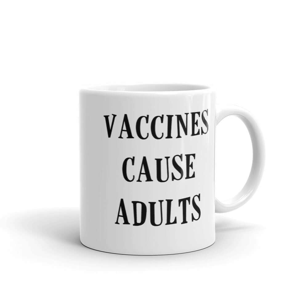 White ceramic mug with the words Vaccines cause adults printed on both sides.