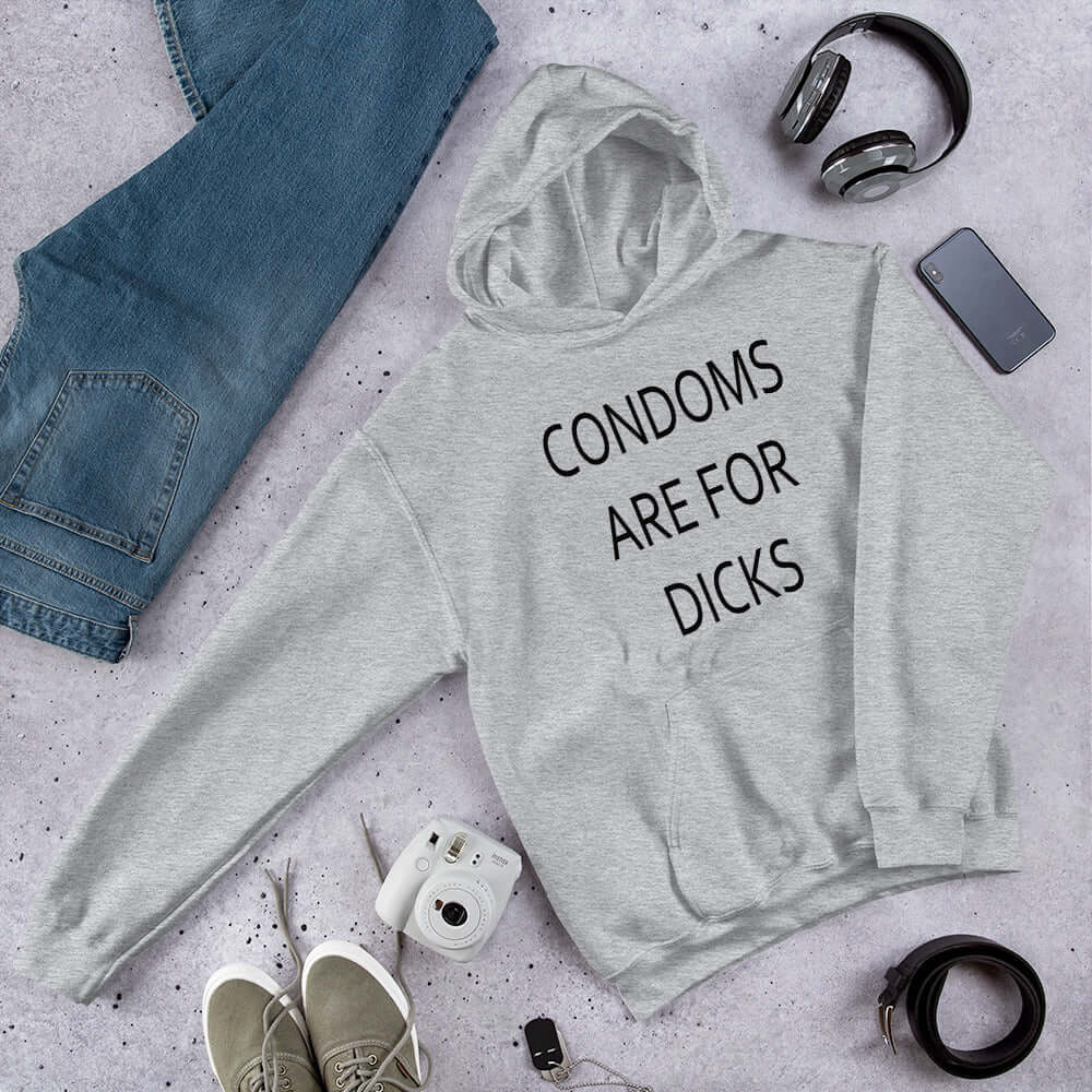 Light grey hoodie sweatshirt with the phrase Condoms are for dicks printed on the front.