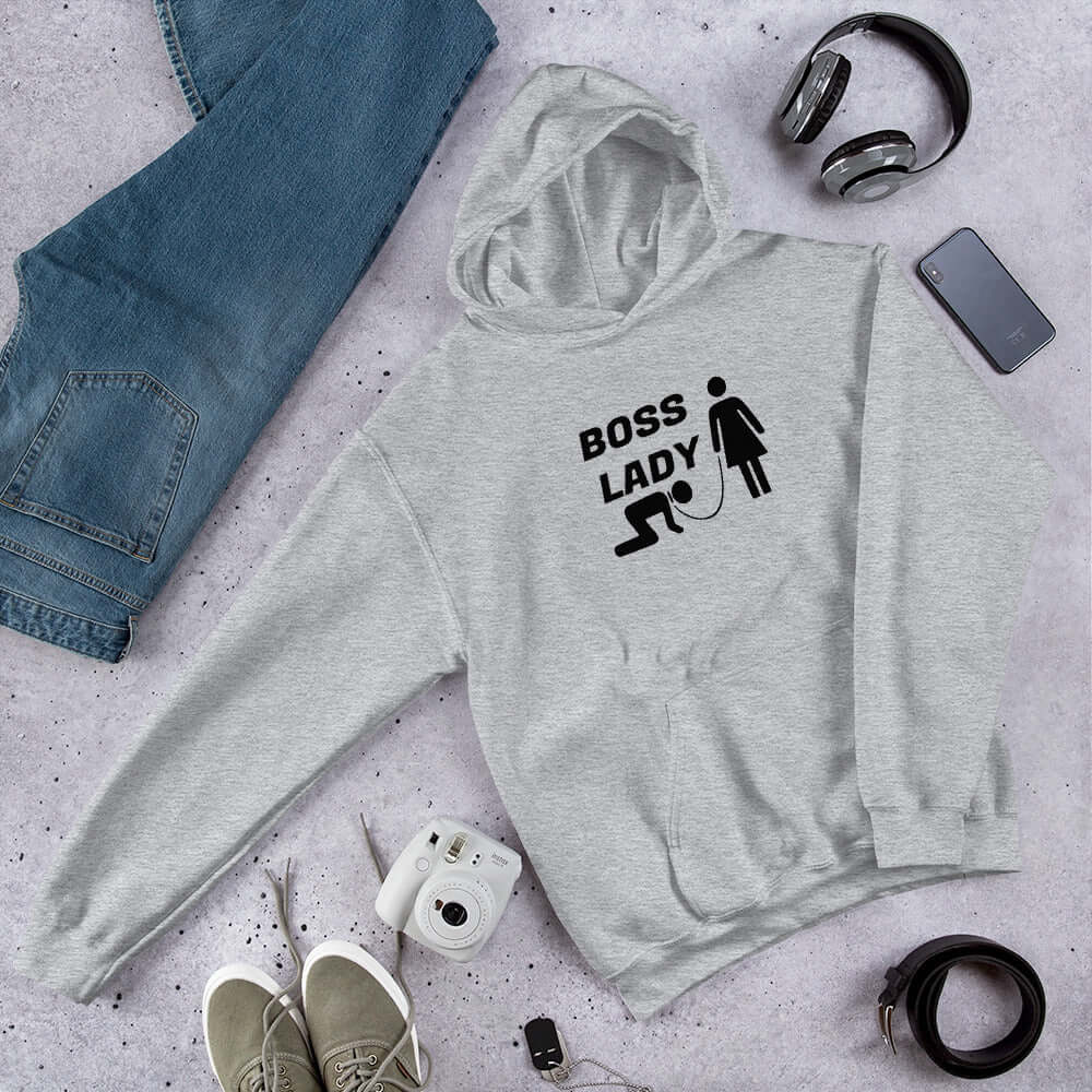 Light grey hoodie sweatshirt with graphic of collared and leashed man on his hands and knees being led by a woman and the words Boss lady printed on the front.