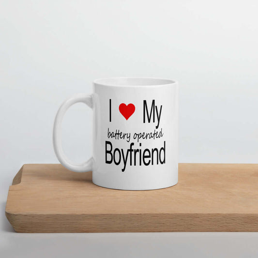 White ceramic coffee mug with the phrase I heart my battery operated boyfriend printed on both sides.