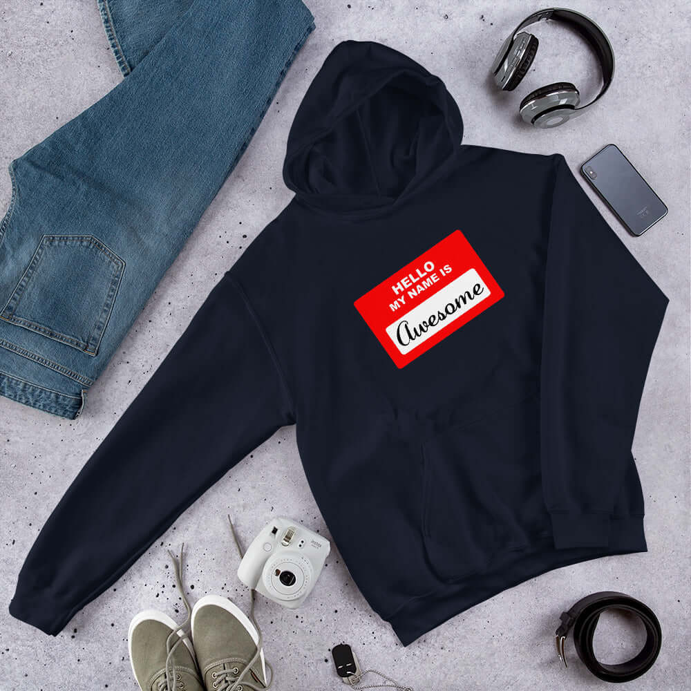 Navy blue hoodie sweatshirt with an image of a classic red and white sticker name tag that says Hello my name is Awesome printed on the front.