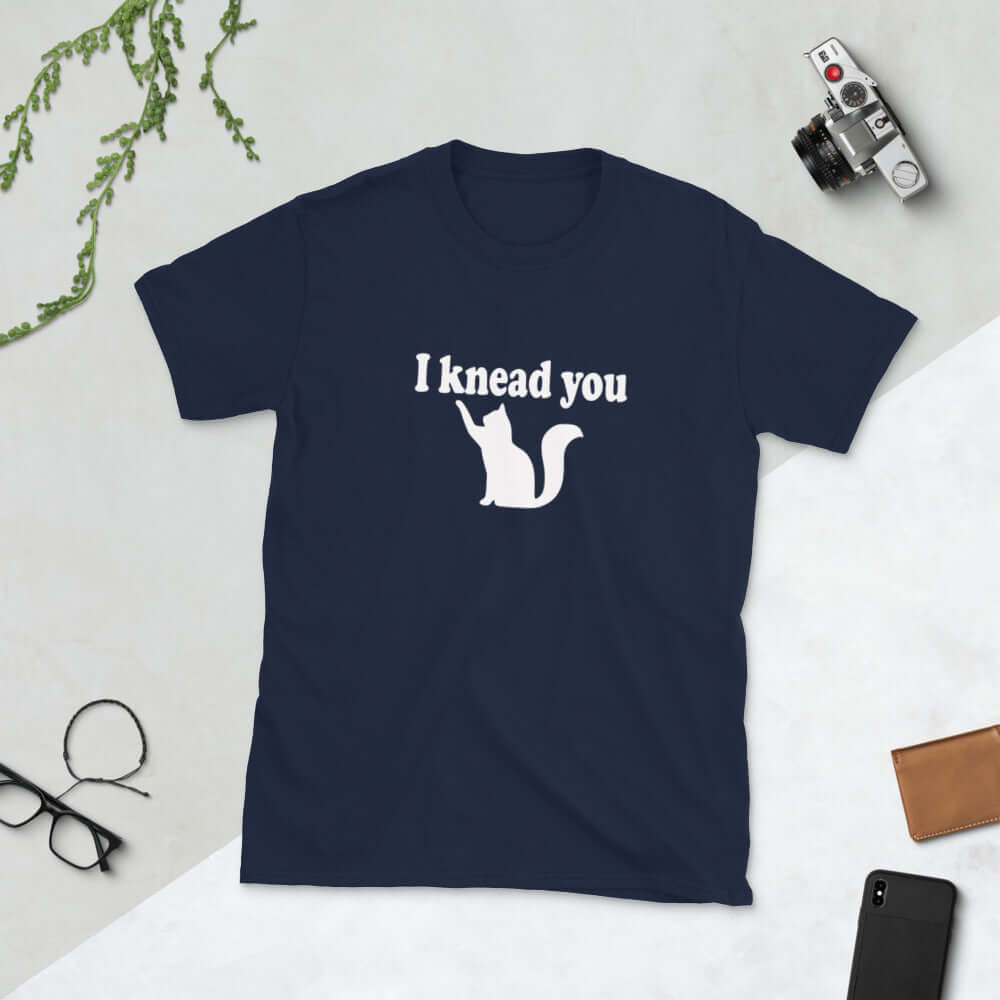 Navy blue t-shirt that has a pun image of a silhouette of a cat and the words I knead you printed on the front.