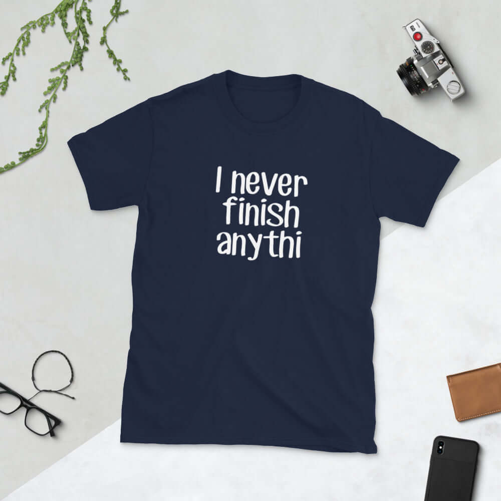 Navy blue t-shirt with the phrase I never finish anything printed on the front The letters n and g are missing from the word anything.