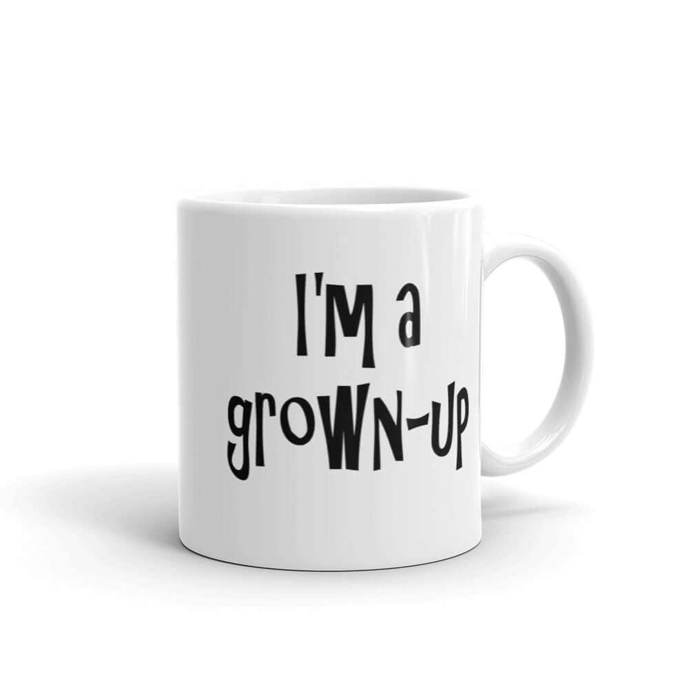 White ceramic coffee mug with the words I'm a grown-up printed on both sides of the mug.