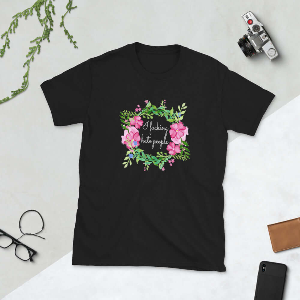 Black t-shirt with pink and green floral wreath image and the words I fucking hate people printed on the front.