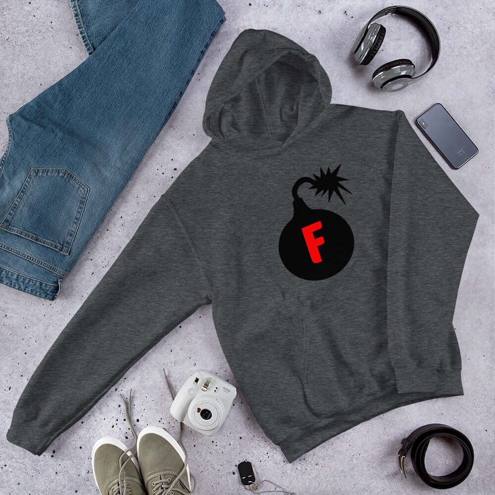 Dark heather grey hoodie sweatshirt with an image of a bomb & the letter F printed in the center. The graphics are printed on the front of the hoodie.