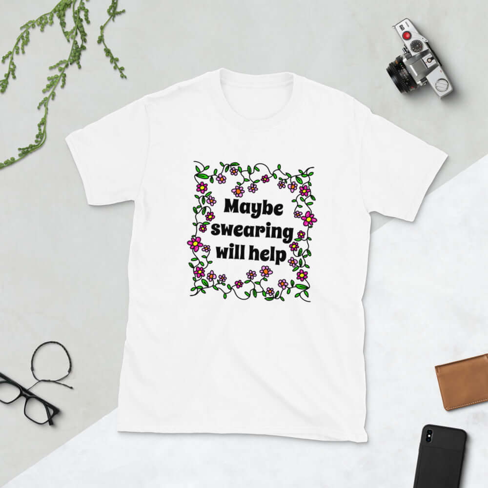 White t-shirt with a floral graphic and the phrase Maybe swearing will help printed on the front.