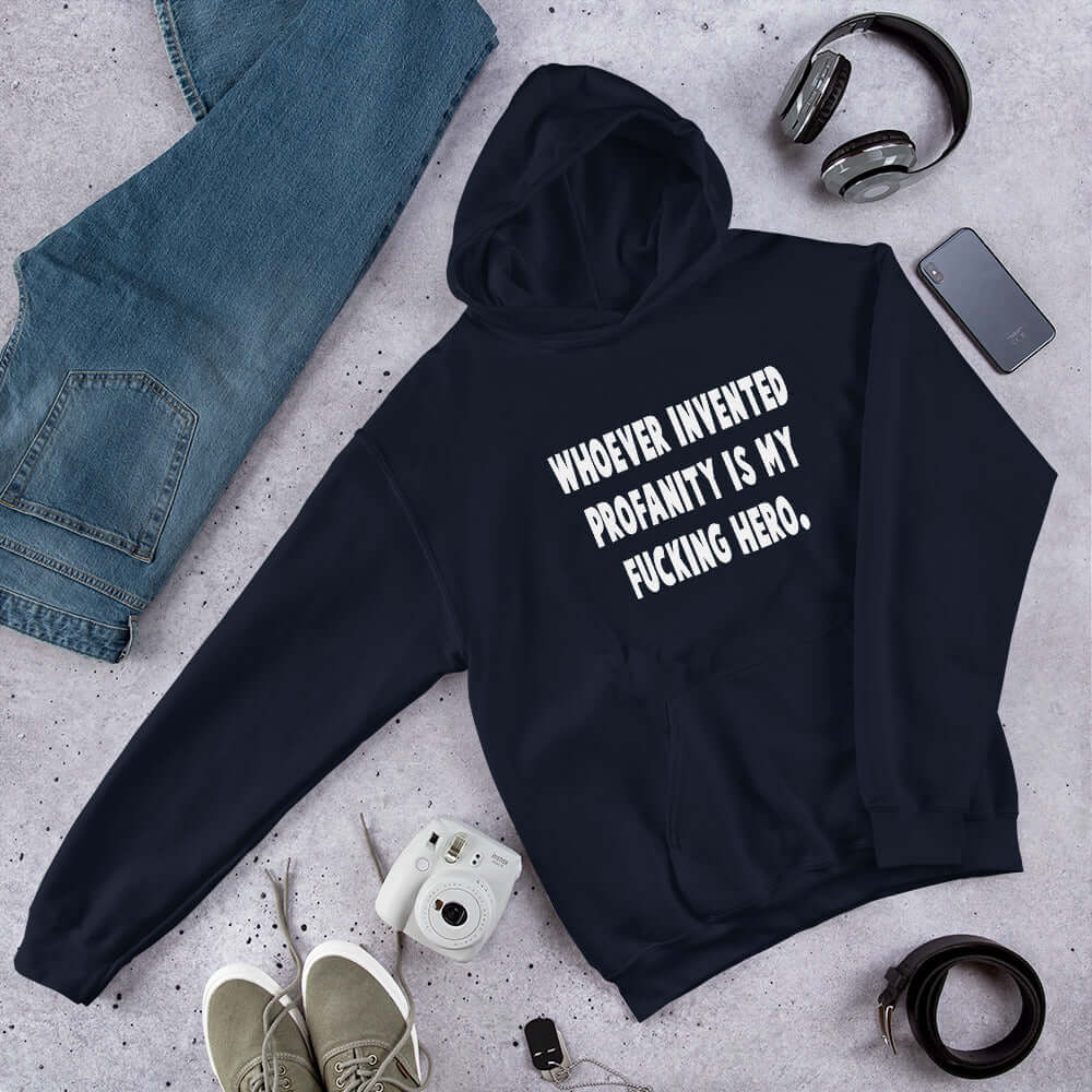 Navy blue hoodie sweatshirt with the phrase Whoever invented profanity is my fucking hero printed on the front.