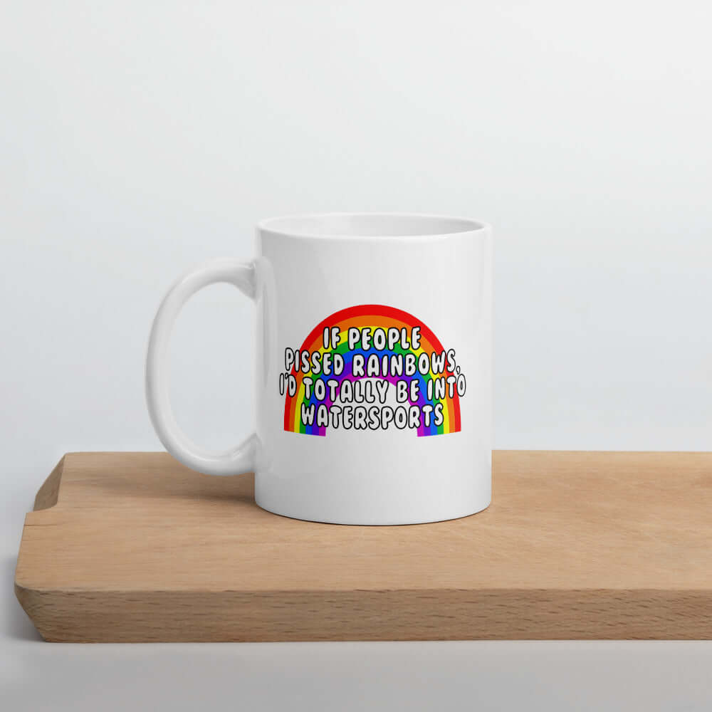 White ceramic coffee mug with an image of a rainbow and the phrase If people pissed rainbows I'd totally be into watersports printed on both sides of the mug